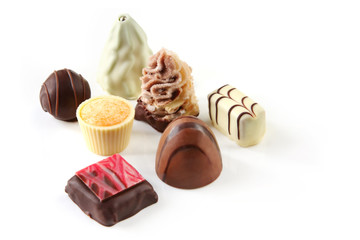 Fancy hand-made chocolates, isolated on white. 