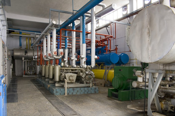 Industrial size generators in a factory machinery room