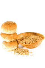 Three Bread Rolls and Basket of Wheat Grains