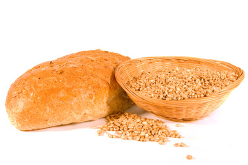 Seeded Loaf of Bread with Basket of Wheat Grain
