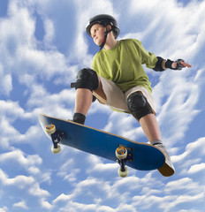 Young skateboarder make a jump on skateboard