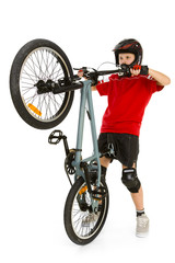 Young biker picking up front wheel his BMX