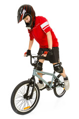 Young boy in red T-shirt cycling on BMX