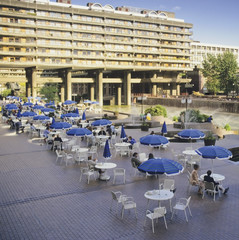 open air cafe and restaurant with block of modern flats