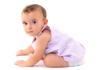 Baby Girl learning how to crawl on white .