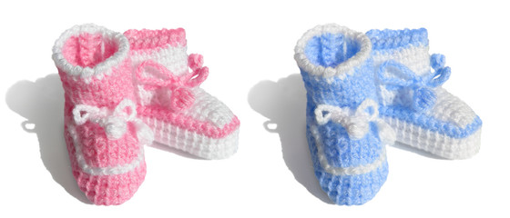 Newborn baby, girl or boy. symbols Tiny bootees - pink, blue