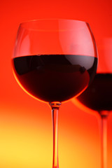 Wine glasses against red background