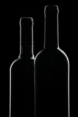 Wine bottles against black background