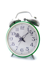 Old green alarm clock on a white background