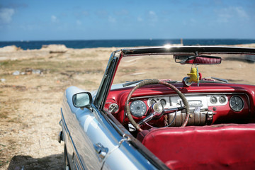 cuban vintage car parked on the seacost in havana