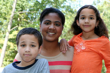 A mother with her young children of a mixed race family