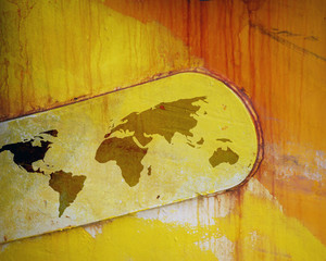 Outline map of world overlaid onto rusting paintwork of ship