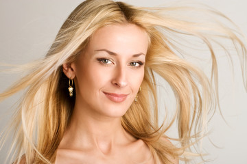 beautiful blonde girl with hair fluttering in the wind