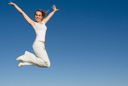 Happy Fit Healthy Woman Jumping For Joy