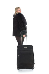 Beautiful blonde with valise on black background