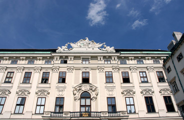 Fototapeta na wymiar Hofburg windows, balcony, roof sculpture and decorations.