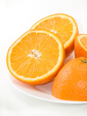 Sweet fresh oranges on the plate over white background