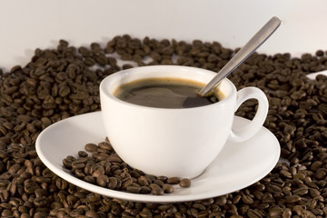 Cup of coffee and coffee beans background