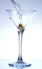Martini being poured into a glass (toned in blue).