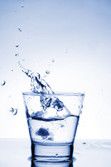 Close up view of the splash in water (toned in blue)