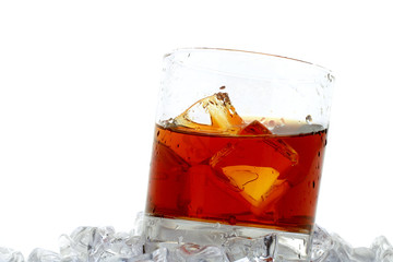 glass of whiskey with ice cubes on white background