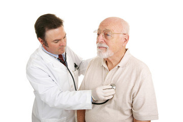 Doctor listening to a senior patient's heartbeat.  Isolated 