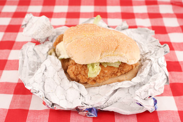 fast food crispy chicken burger still in wrapper 