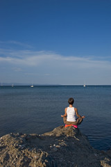 Fototapeta na wymiar woman making of yoga at the seaside