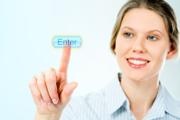 Portrait of businesswoman looking at the enter button 