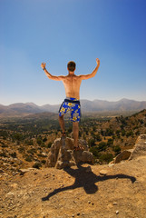 Young guy relaxing in mountains