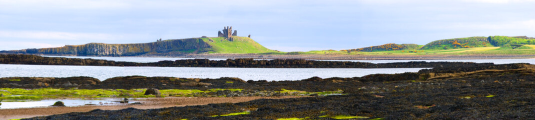 Panorama of Embleton Bay with view of Dunstanburgh Castle