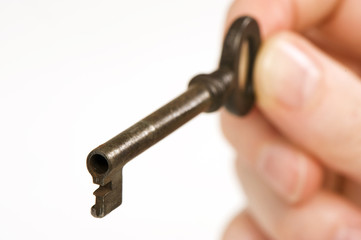 a hand holding an old key. 