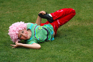 Fototapeta na wymiar girl dressed up as hippy in pink wig