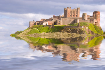 Fantasy view of Bamburgh Castle surrounded by water - obrazy, fototapety, plakaty