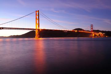 Glowing Golden Gate Bridge at sunset. Shot from Fort Point area.