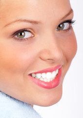 Smiling  young woman face. Over white background.