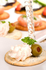 cracker with salmon cream cheese spread and olive