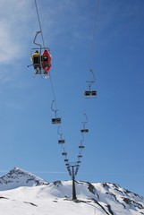 Winter scene of one couple sitting on emty ski lift