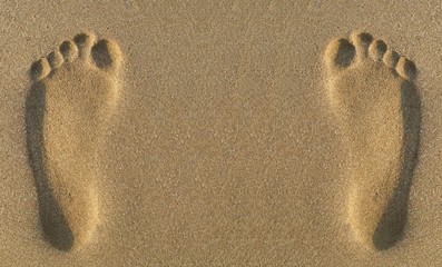 Fototapeta na wymiar Two parallel footprints in sand