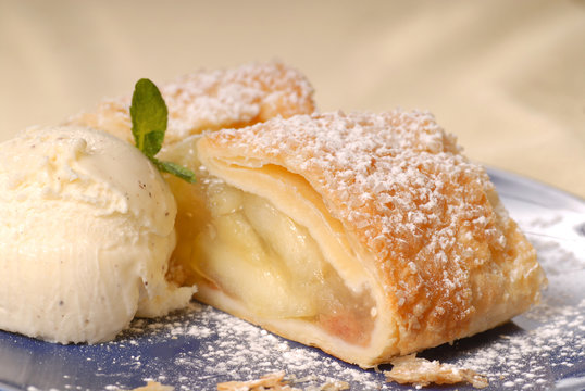 Freshly baked apple strudel with vanilla ice cream