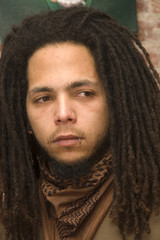 young man with dreadlocks and piercing