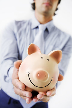 business amn holding fat,happy piggybank