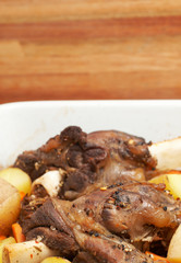 Marinated lamb shanks on the bone cooked with potatoes 