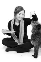 woman is feeding dog snacks
