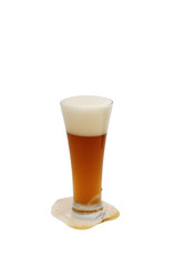 Glass of honey brewed wheat beer on white