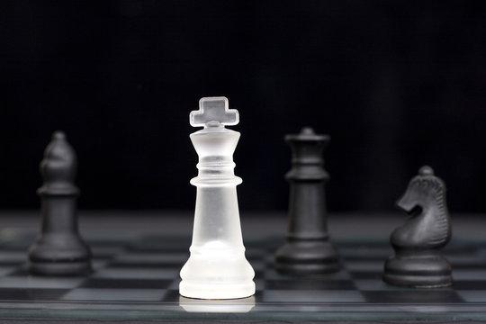 The white king comes under attack in a game of chess