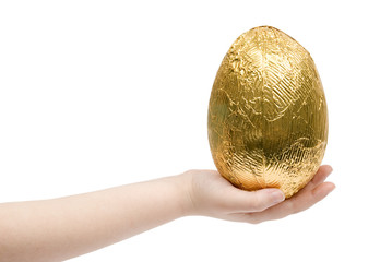 A child holding a golden wrapped Easter Egg