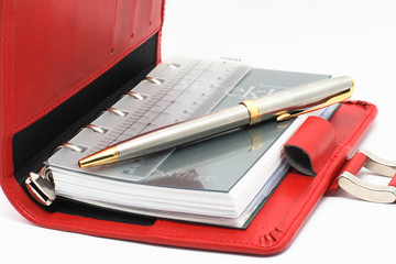 REd notebook on white background