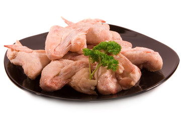 Chicken wings on black plate - isolated
