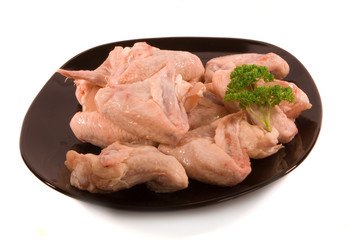 Pile of Chicken Wings on Black Plate ready for Cooking